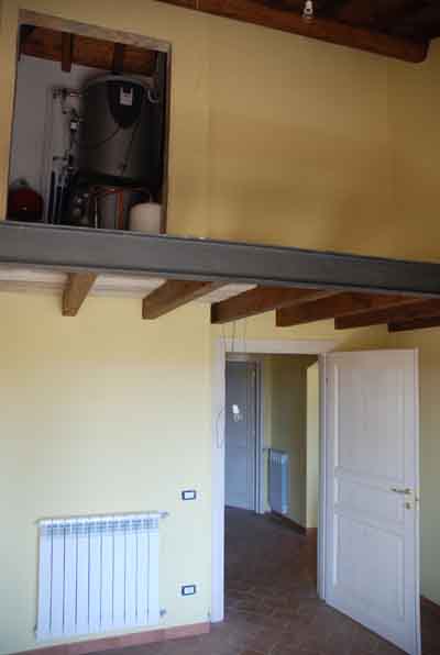 One of the bedrooms on the ground floor with boiler room of the solar panel system